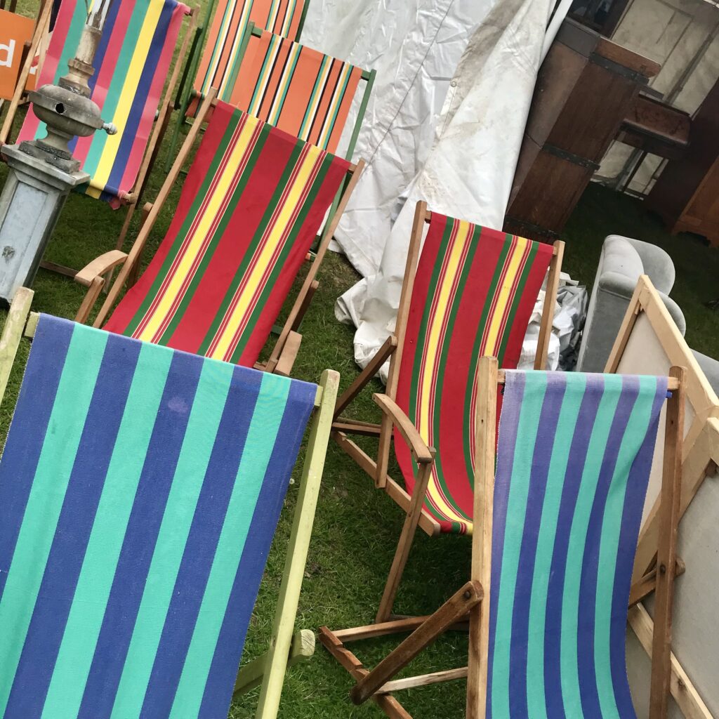 Colourful, striped, vintage deck chairs at an antiques fair.