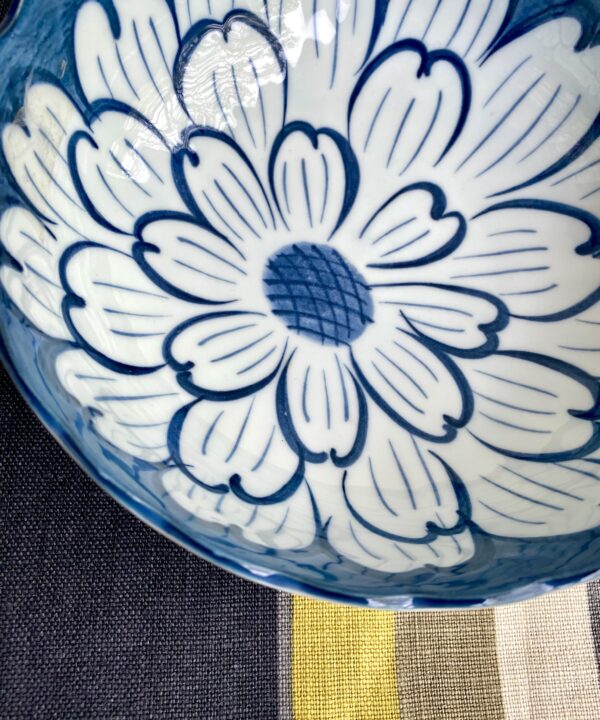 Detail of a vintage bowl with a bold, indigo, Japanese floral design.