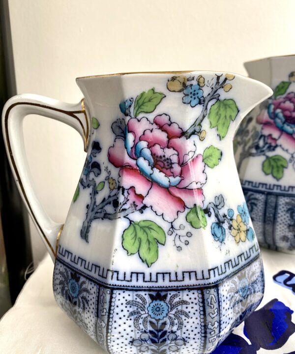 A Chinese-style, vintage floral jug in pinks and blues with a pretty rose pattern.