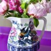 Vintage jugs for flowers. Losolware 'Shanghai' jug filled with roses and peonies on a purple Perspex side table.