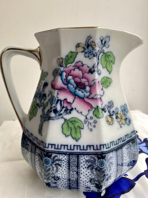 Jug for flowers in a vintage, Chnese-style design. Blues and pinks are the main colours.