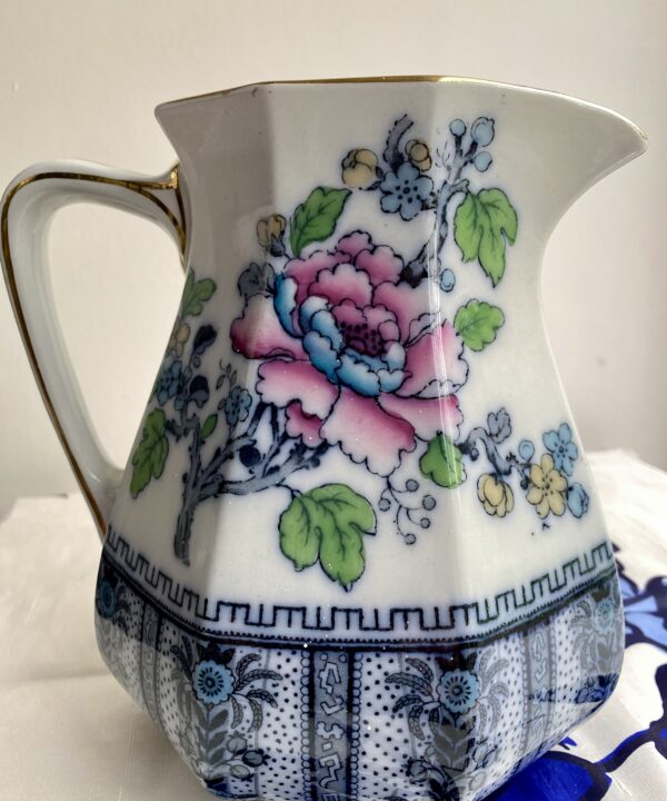 Jug for flowers in a vintage, Chnese-style design. Blues and pinks are the main colours.