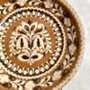 A vintage, decorative wall plate from a Hungarian pottery in earthy browns, creams and terracotta.