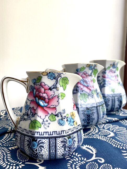 Jugs for flowers. Vintage floral china jugs depicting pink blooms and a colourful bird on the reverse.