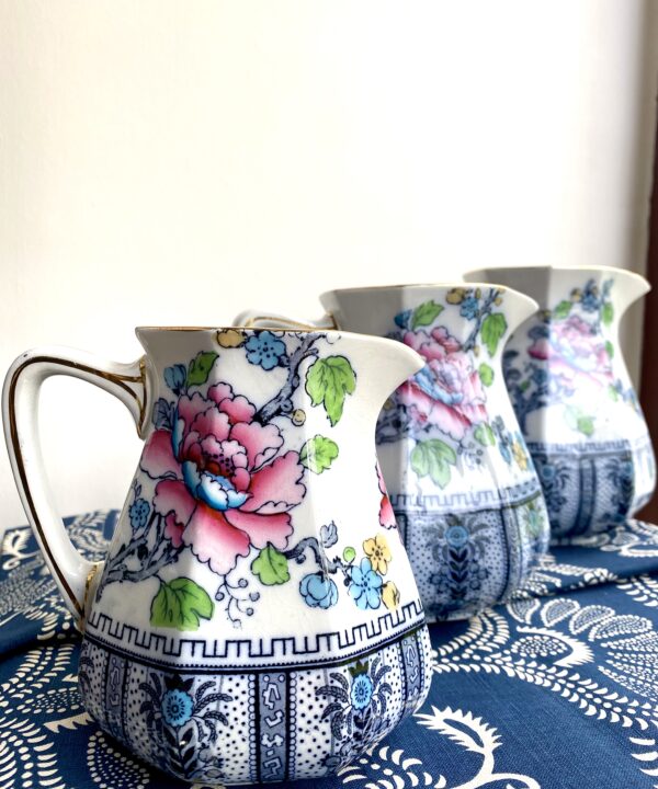 Jugs for flowers. Vintage floral china jugs depicting pink blooms and a colourful bird on the reverse.