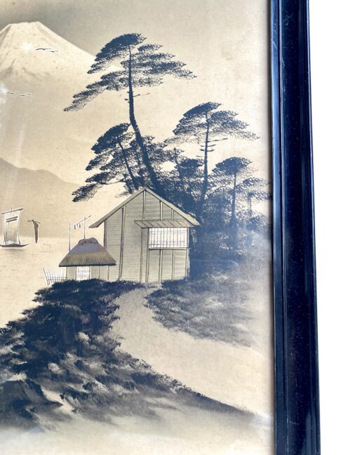 Close-up of a Japanese landscape print depicting trees and a gold-accented hut in the foreground.