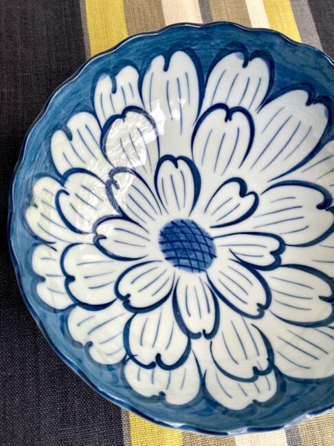 An elegant Japanese bowl with floral décor in indigo blue hues.