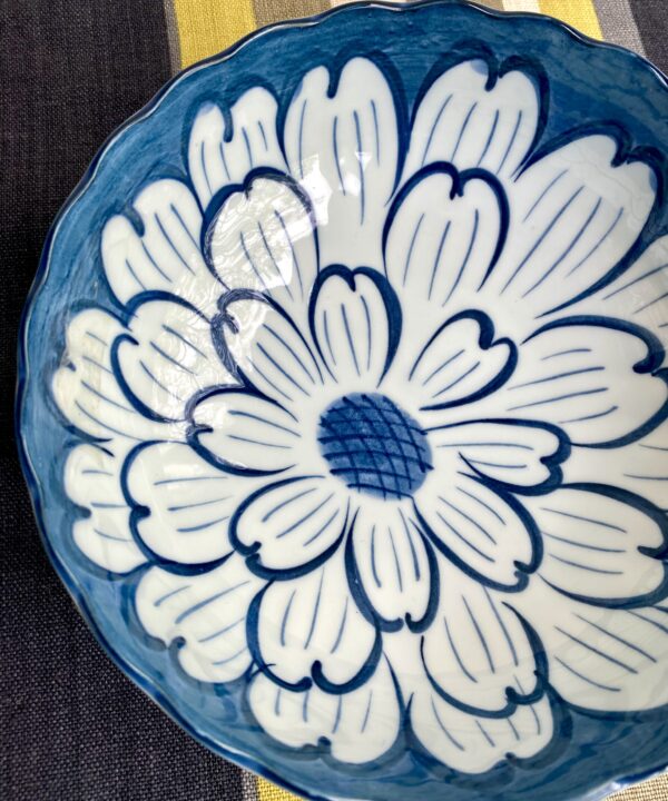 An elegant Japanese bowl with floral décor in indigo blue hues.