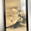 Vintage Japanese landscape art with gold accents and framed in black.