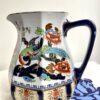 A rust and blue-coloured vintage ceramic jug perfect for a floral display.