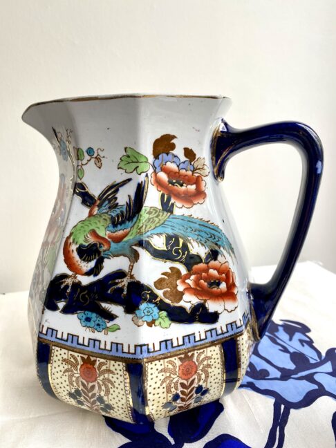 A rust and blue-coloured vintage ceramic jug perfect for a floral display.