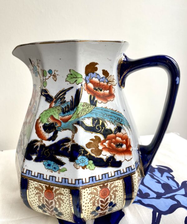 A rust and blue-coloured vintage ceramic jug perfect for a floral display.