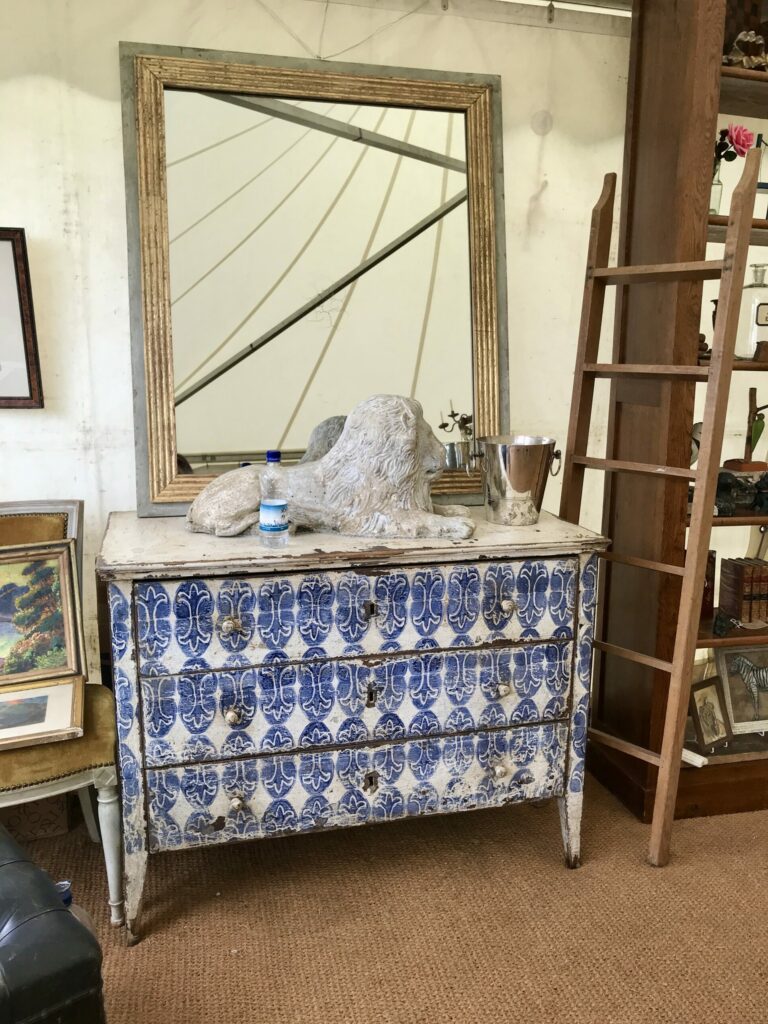 A stencilled blue and white antique chest of drawers from Charpentier.