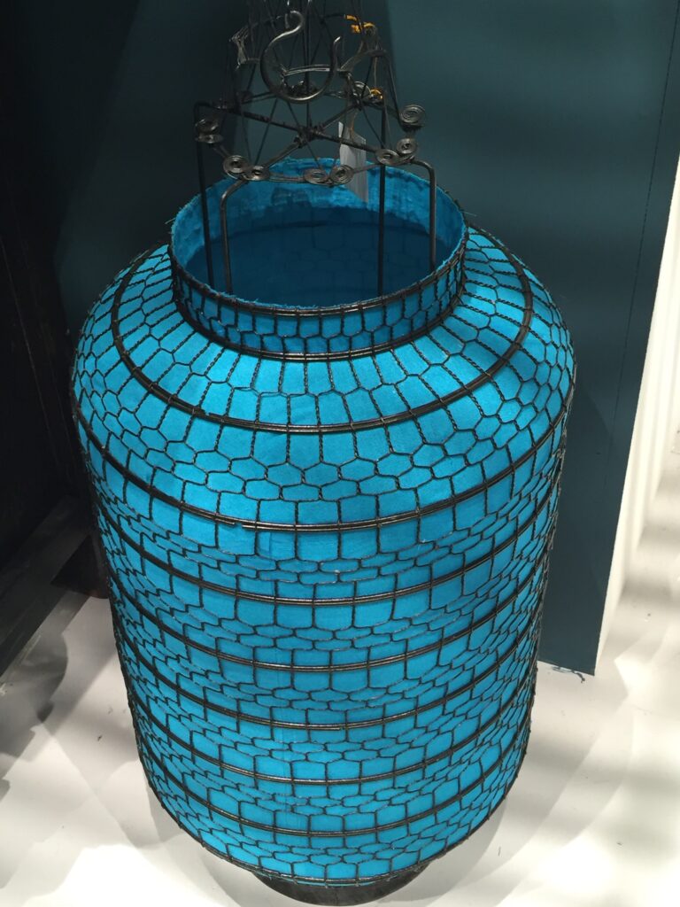 A blue fabric and metal lantern by Asiatides.