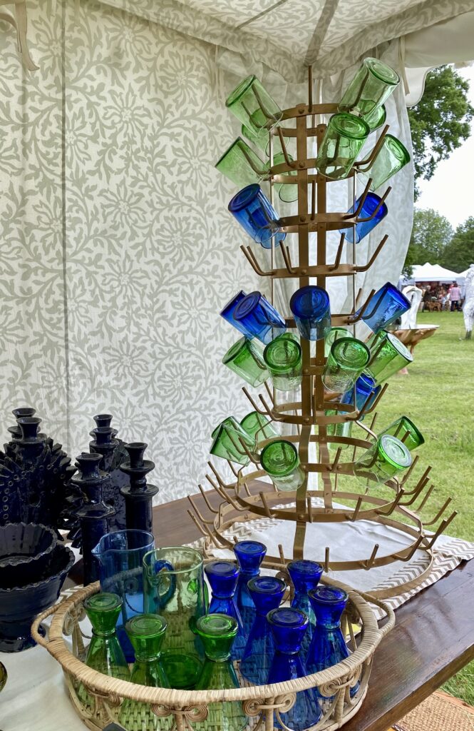 Blue and green coloured glassware at Henley Décor Fair in a stand by the Raj Tent Club.