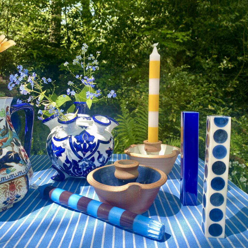 Decorate with blue and white by browsing new in finds from Designs By Origin: pretty blue and white decorative accessories shown here in a garden setting.