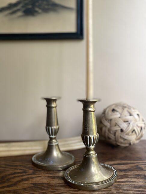 A pair of vintage brass candlesticks.