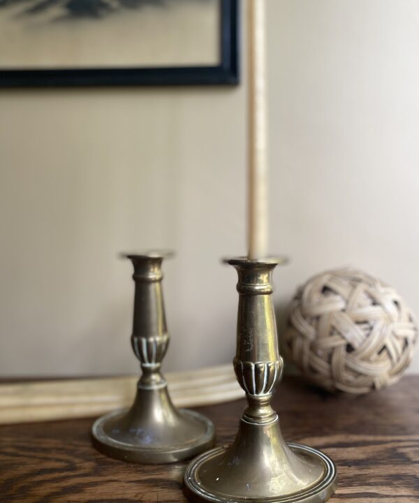 A pair of vintage brass candlesticks.