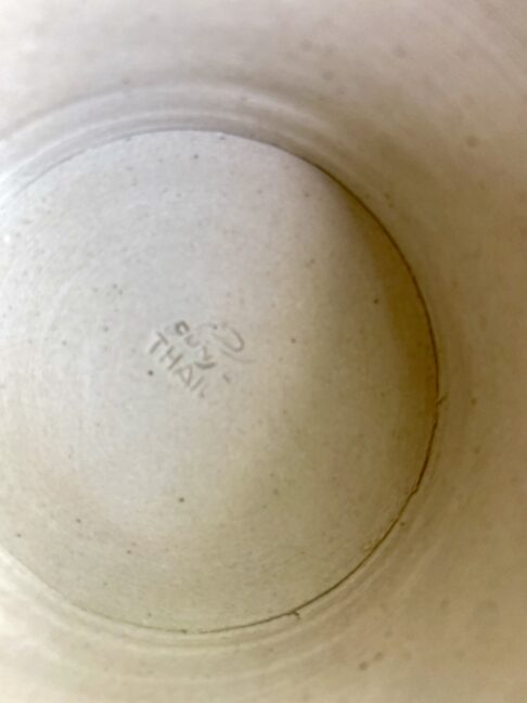 The Thai back stamp on a ceramic, footed dish.