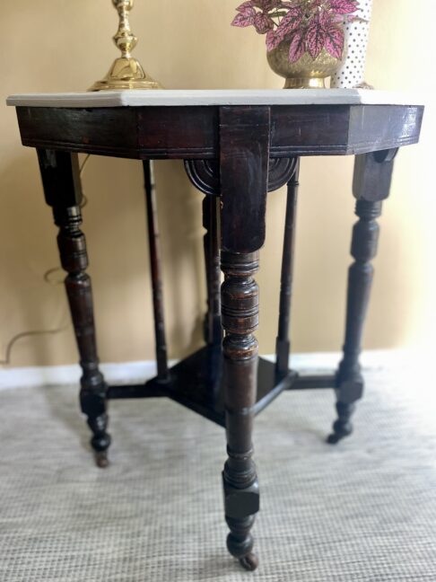 An antique, Edwardian side table on castors with a newly painted, octagonal top.