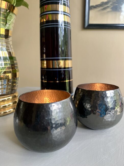 A pair of metal beaten tea light holders.