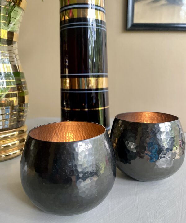 A pair of metal beaten tea light holders.