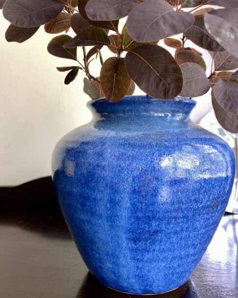 Detail of the mottled glaze on a vivid blue handmade pot.