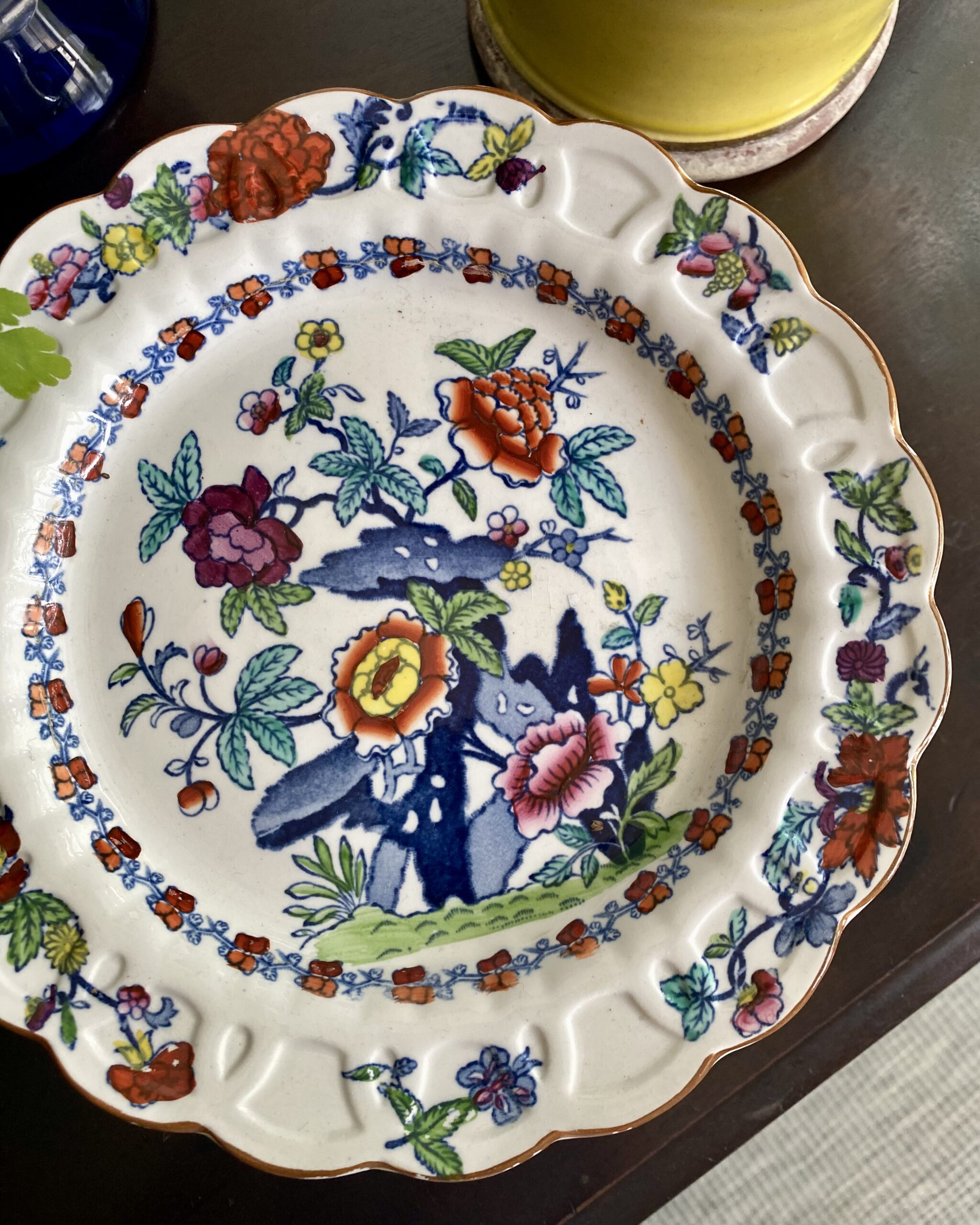 Detail of a colourful, floral antique cake stand.