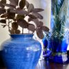 A cornflower blue pottery vase or pot from an artisan pottery studio.