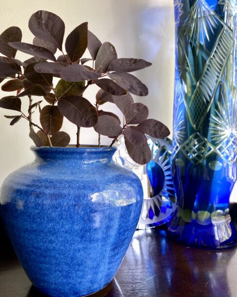 A cornflower blue pottery vase or pot from an artisan pottery studio.