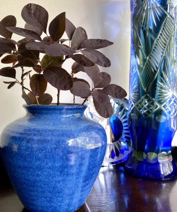 A cornflower blue pottery vase or pot from an artisan pottery studio.