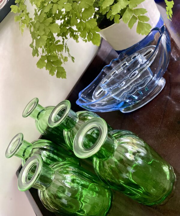 Coloured glassware vases to accessorize a dining room interior vignette.