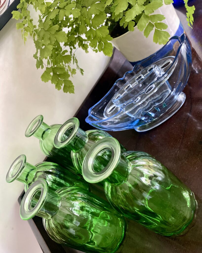 Coloured glassware vases to accessorize a dining room interior vignette.