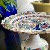 A vintage floral cake stand by Booths with brightly coloured decoration.