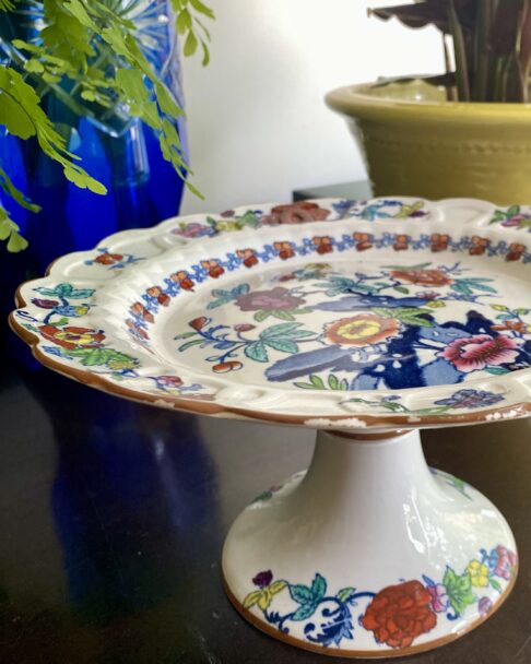 A vintage floral cake stand by Booths with brightly coloured decoration.