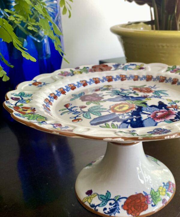 A vintage floral cake stand by Booths with brightly coloured decoration.