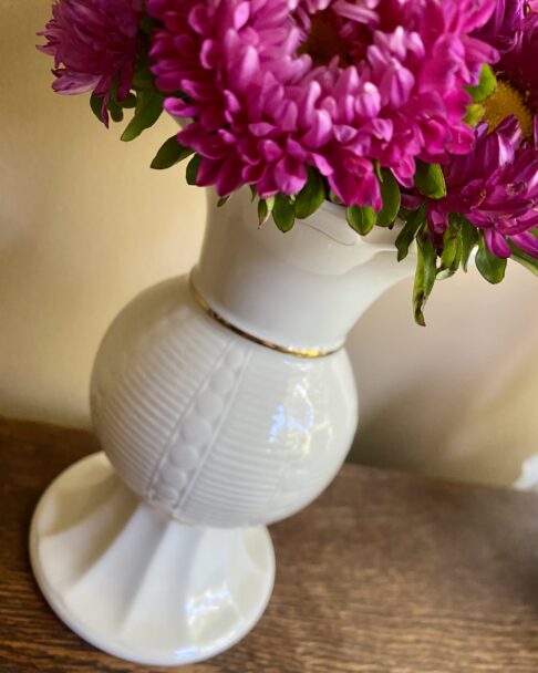 A pretty, petite cream flower vase handmade in Ireland.