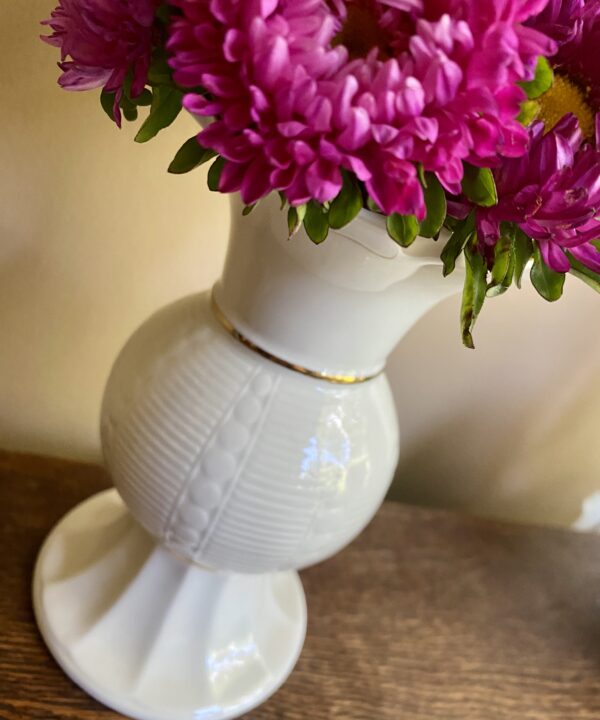 A pretty, petite cream flower vase handmade in Ireland.