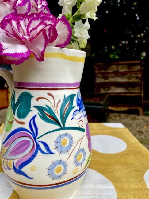 Close up of colourful Poole pottery hand-painted décor.