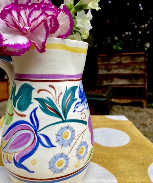 Close up of colourful Poole pottery hand-painted décor.