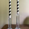 A pair of vintage crystal candlesticks styled with stripy black and beige candlesticks.