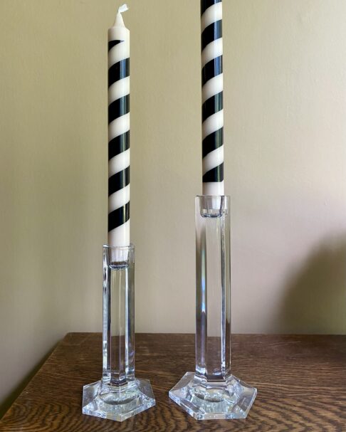 A pair of vintage crystal candlesticks styled with stripy black and beige candlesticks.