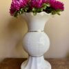 Cream footed vase in Donegal Parian ware china. The frilled top and central section have a gold trim.