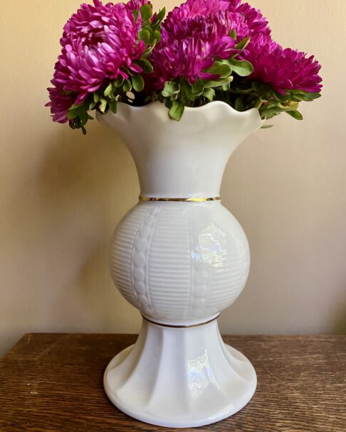 Cream footed vase in Donegal Parian ware china. The frilled top and central section have a gold trim.