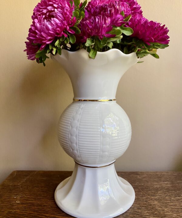 Cream footed vase in Donegal Parian ware china. The frilled top and central section have a gold trim.