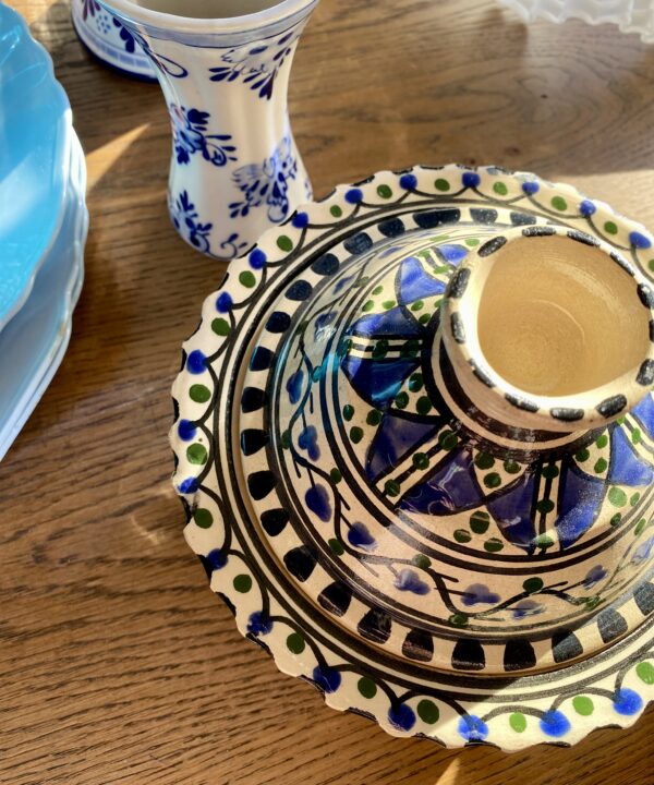 An overhead view of a hand-painted Moroccan lidded pot or decorative miniature tagine.