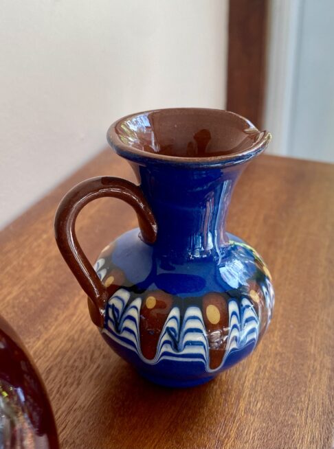 A brilliant blue glazed ceramic urn-handled pot in miniature.