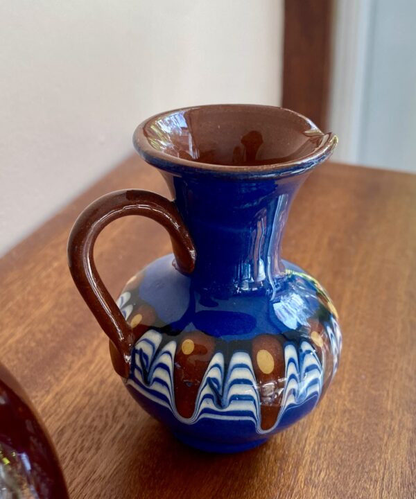 A brilliant blue glazed ceramic urn-handled pot in miniature.