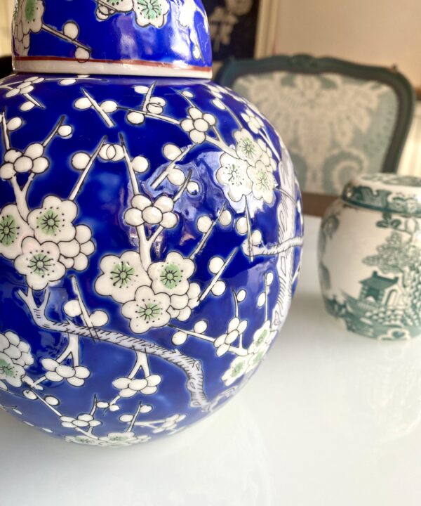 Blossom detail on a blue and white ginger jar.