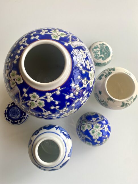 A collection of vintage lidded ginger jars in blue and white.